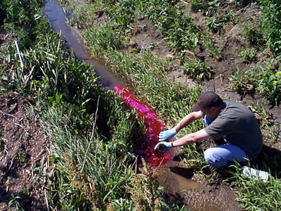 Jason Vogel begins a rhodamine tracer test near the source of a small tributary of Maple Creek.
